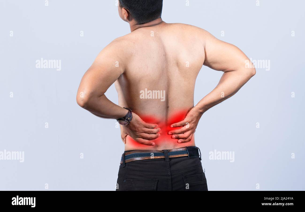 Person with back problems on isolated background, lumbar problems concept, A man with spine problems, a sore person with back pain Stock Photo