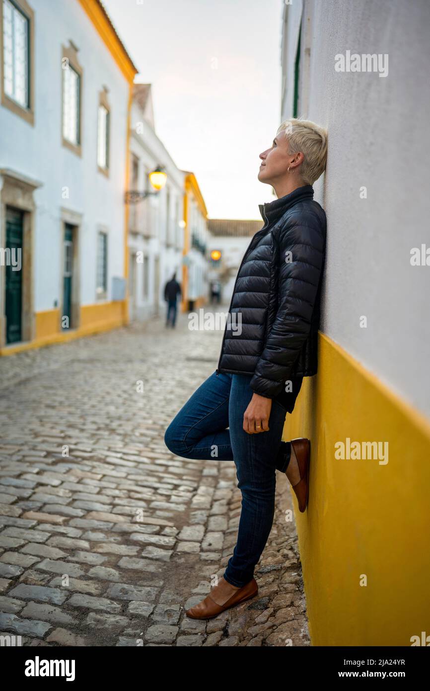 Portrait of blond woman in downtown of Faro, Algarve, Portugal Stock Photo