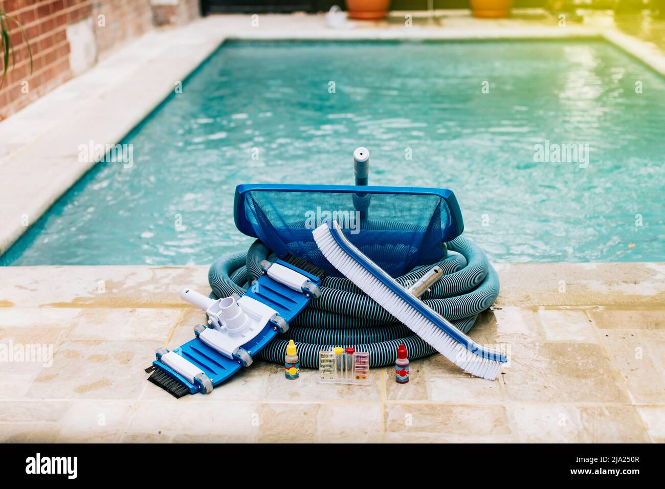 Image of pool cleaning and maintenance kit, vacuum cleaner, ph test