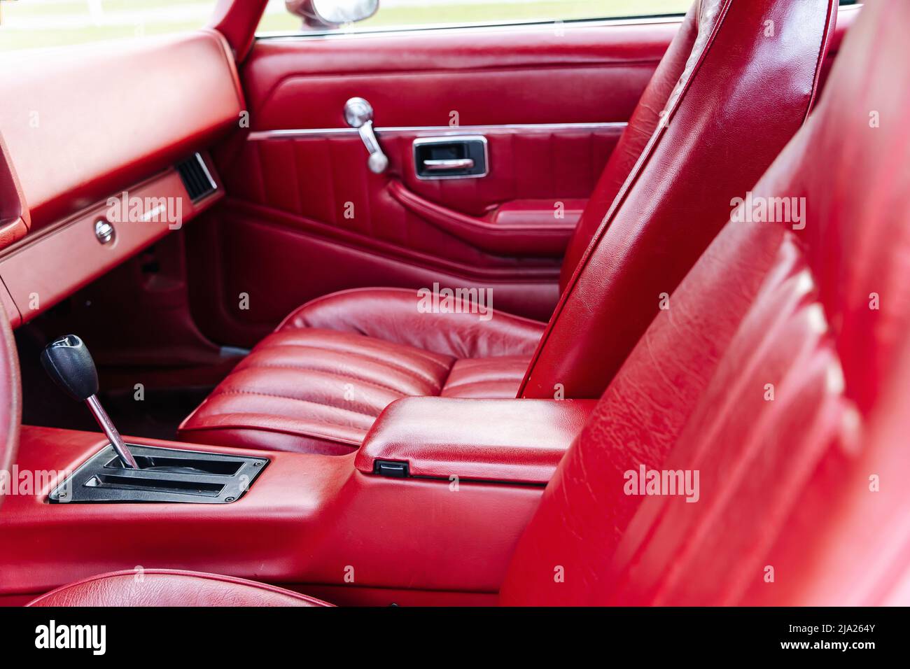 interior is made of red leather of old powerful classic American car Stock Photo