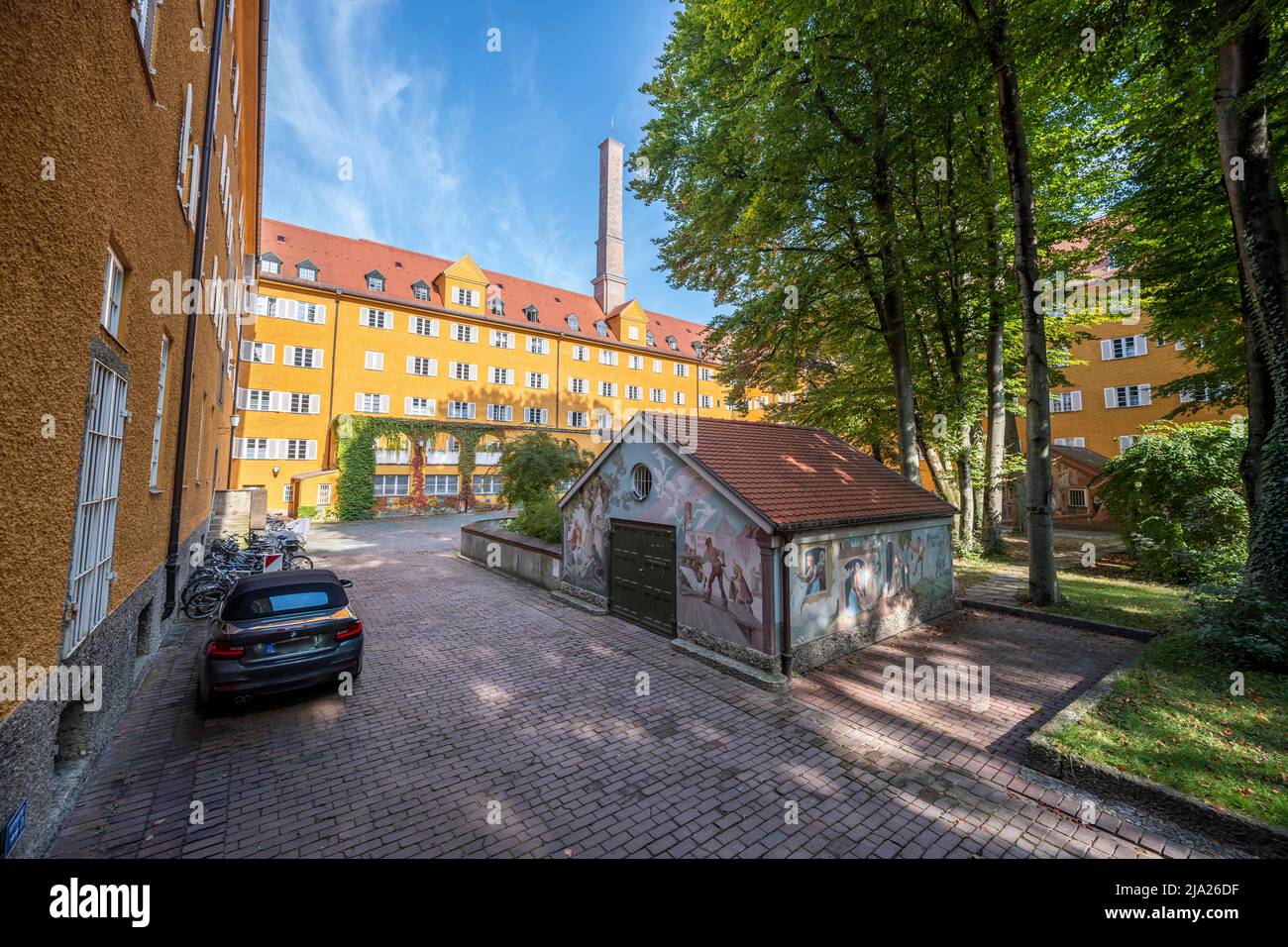 Inner courtyard with yellow apartment buildings, Borstei, heritage-protected housing estate, Moosach district, Munich, Bavaria, Germany Stock Photo