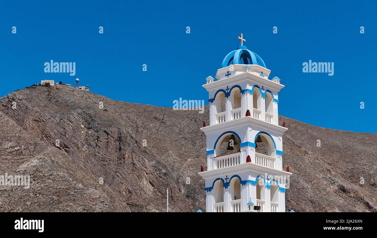 Blue and white bell tower, church, blue cloudless sky, radar station on mountain, Perissa, Santorini Island, Cyclades, Greece Stock Photo
