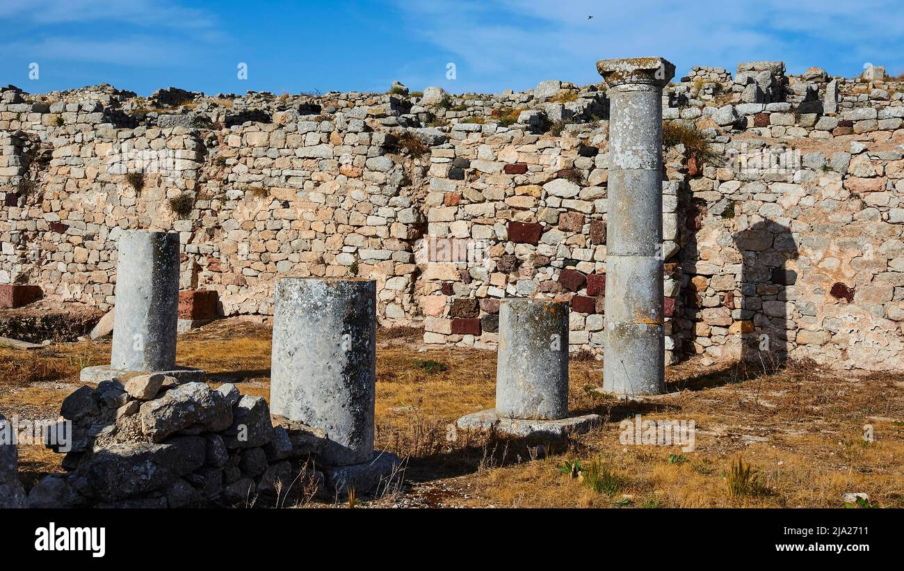 Ancient wall, round columns, blue sky, white clouds, Old Thera, mountain top, archaeological site, Perissa, Kamari, Santorini Island, Cyclades, Greece Stock Photo
