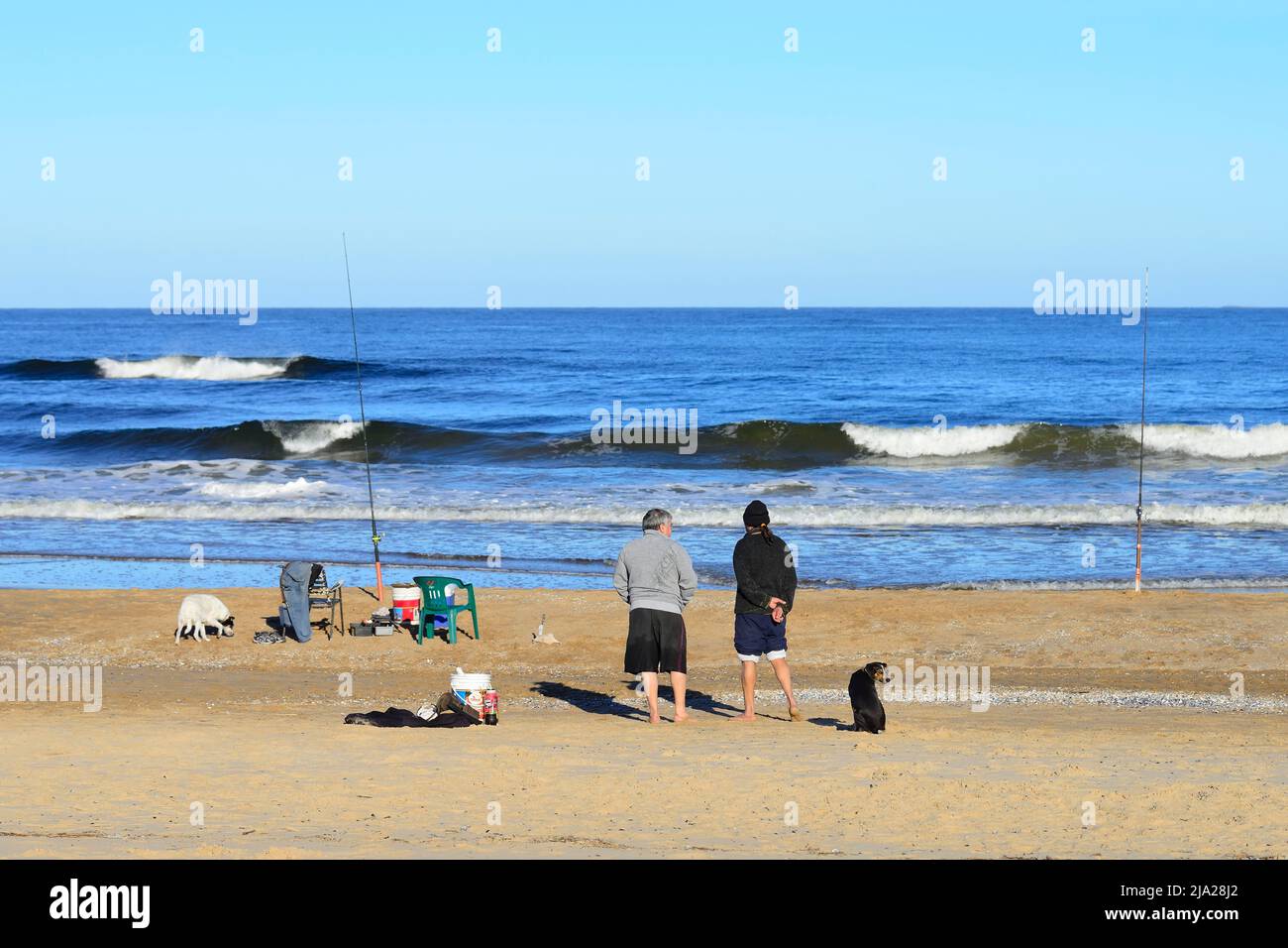 Two anglers on the beach Playa Brava, Punta del Este, Departamento Maldonado, Uruguay Stock Photo