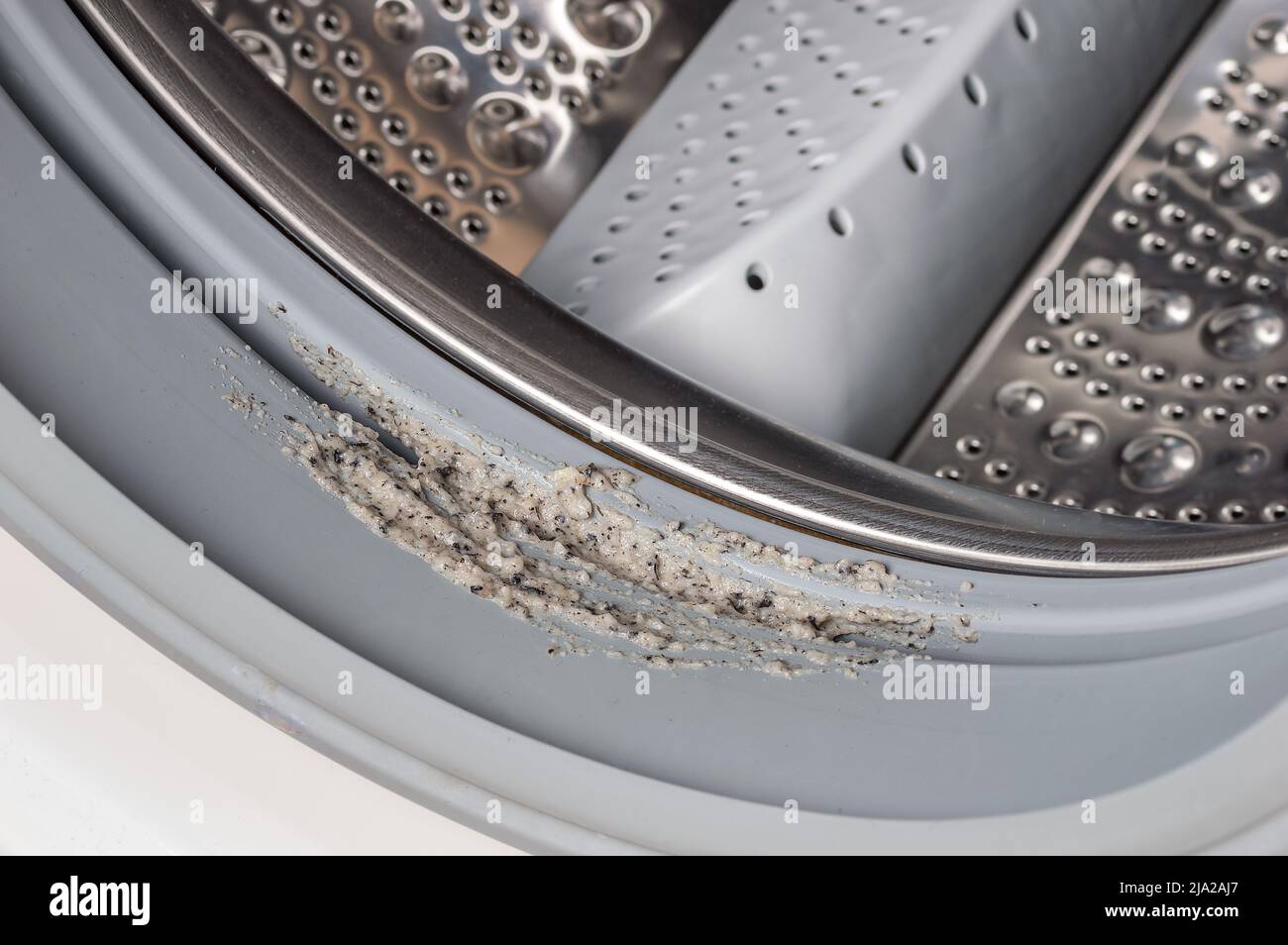 Dirty moldy washing machine sealing rubber and drum close up. Mold, dirt and limescale in