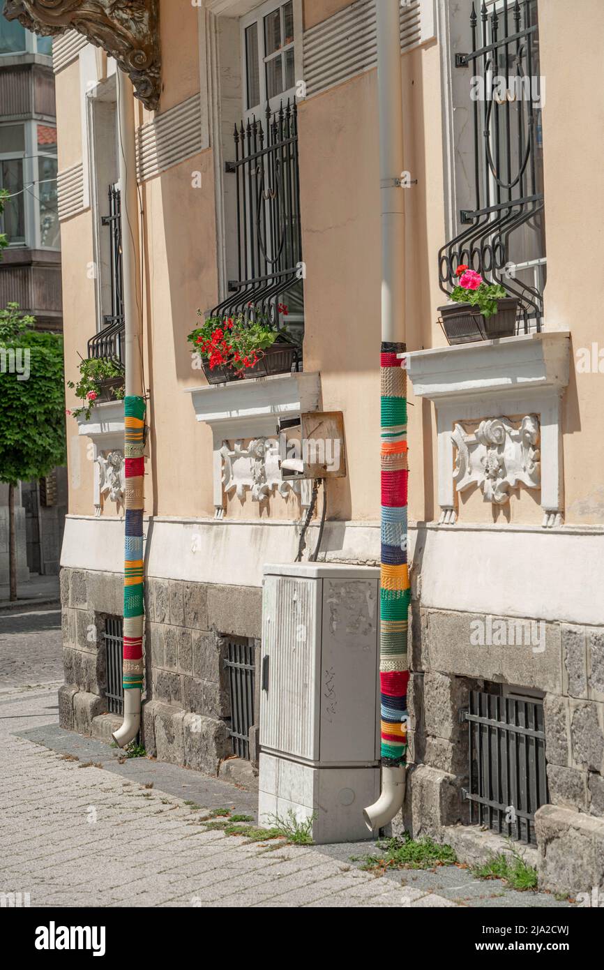 Plovdiv, Bulgaria - 23.05.2022: Two yarn bombed rainwater pipes in the residental district of Plovdiv Stock Photo