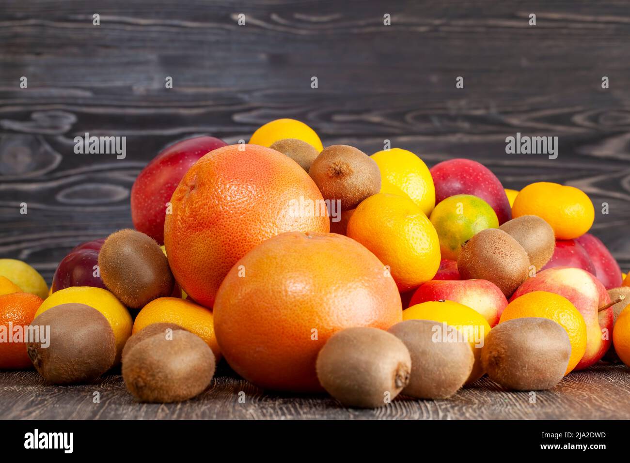 a bunch of citrus tangerines and other fruits together, a large number