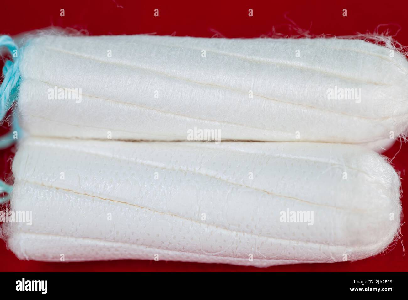 white feminine hygiene products on a red background, feminine hygiene