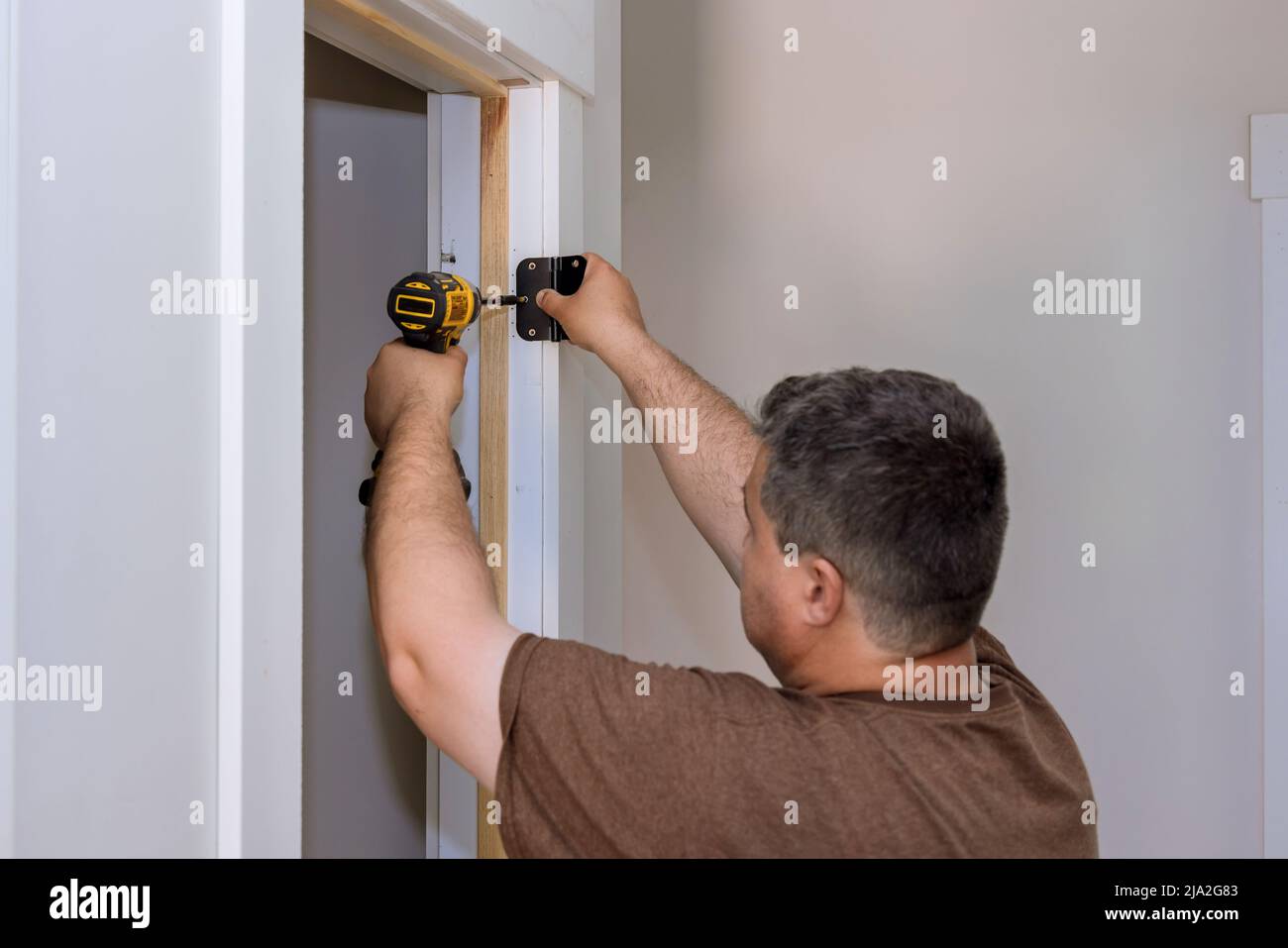 Door hinges on the white door frame with screws Stock Photo Alamy