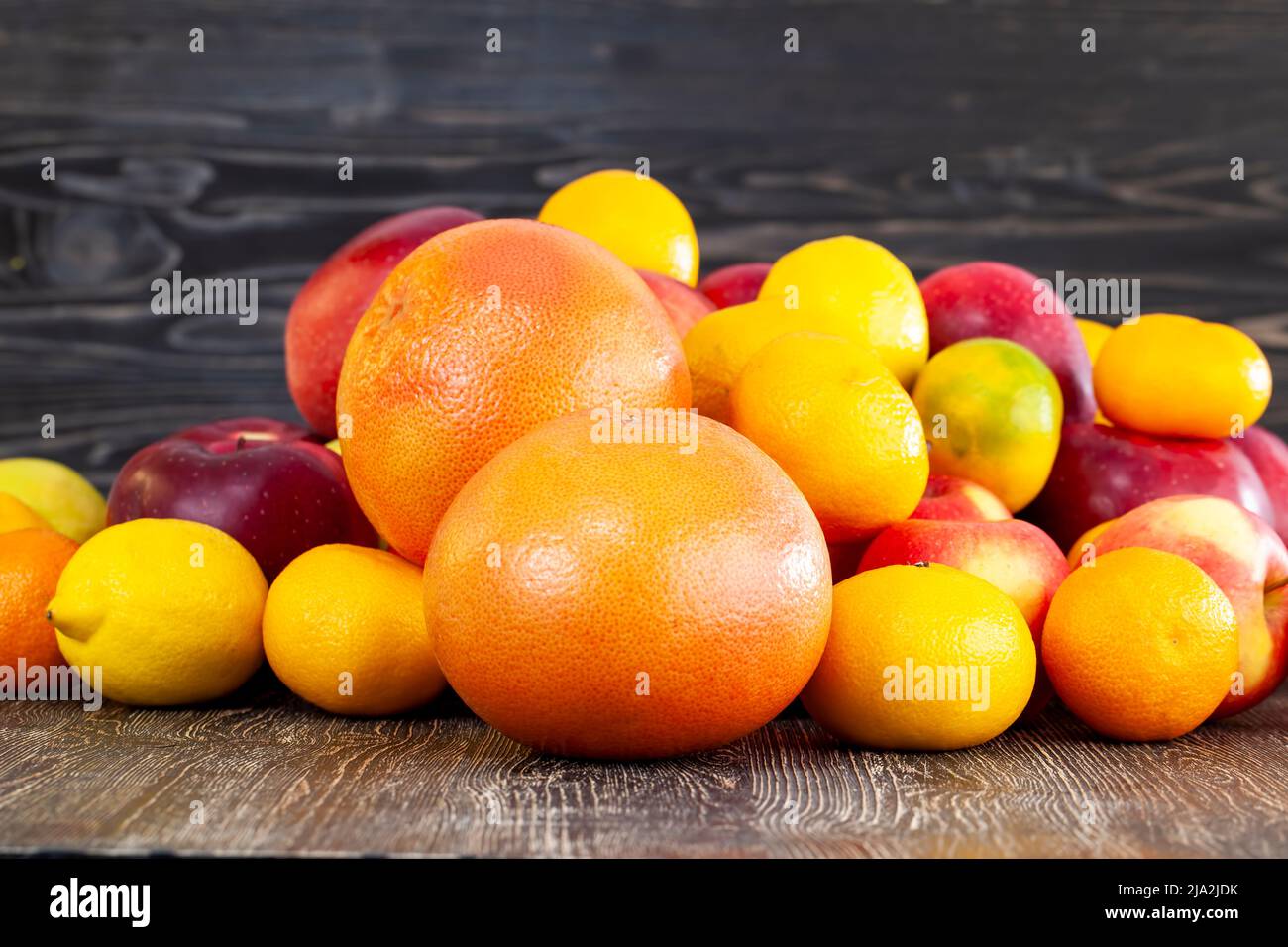 a bunch of citrus tangerines and other fruits together, a large number