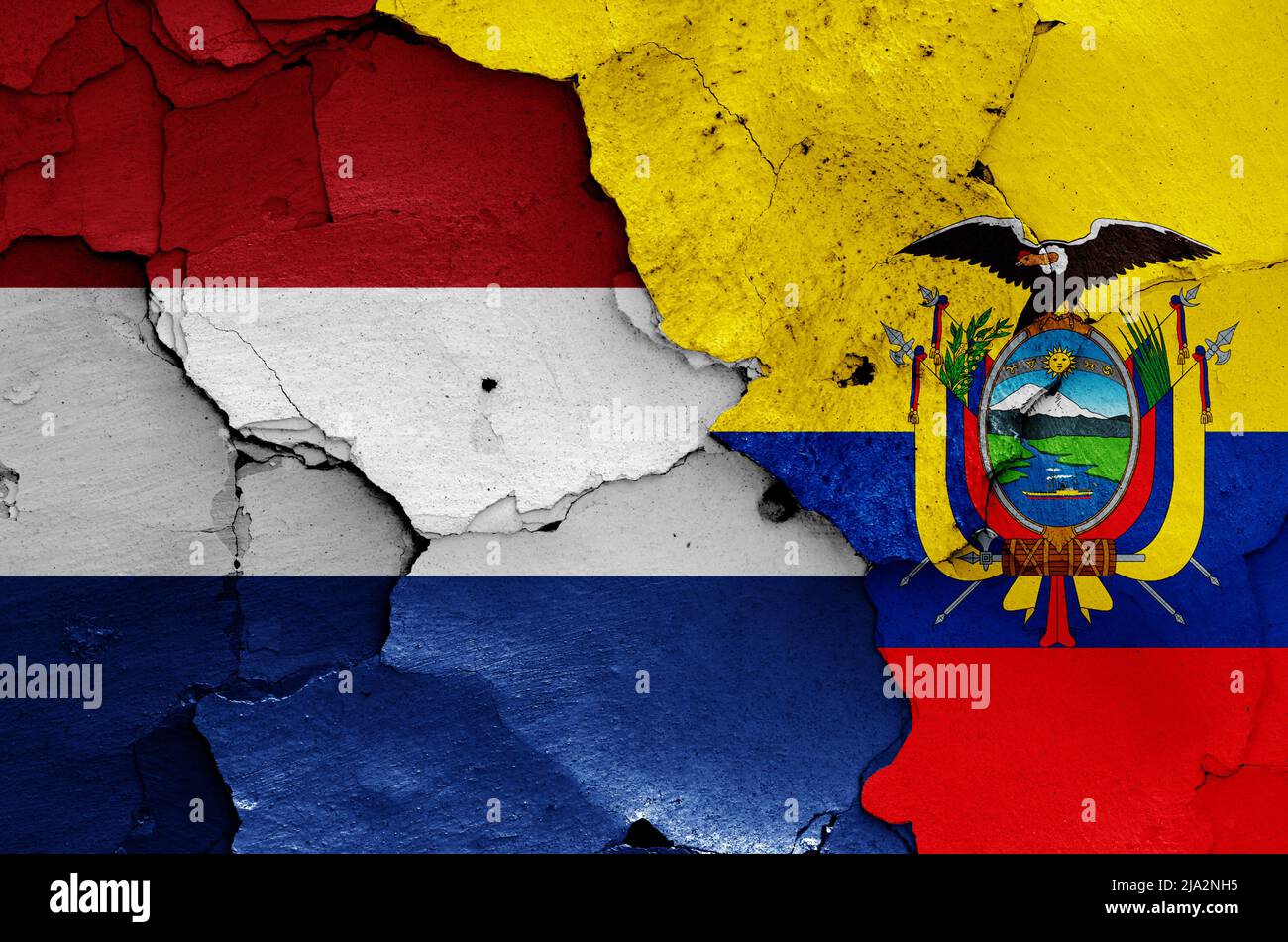 flags of Netherlands and Ecuador painted on cracked wall Stock Photo