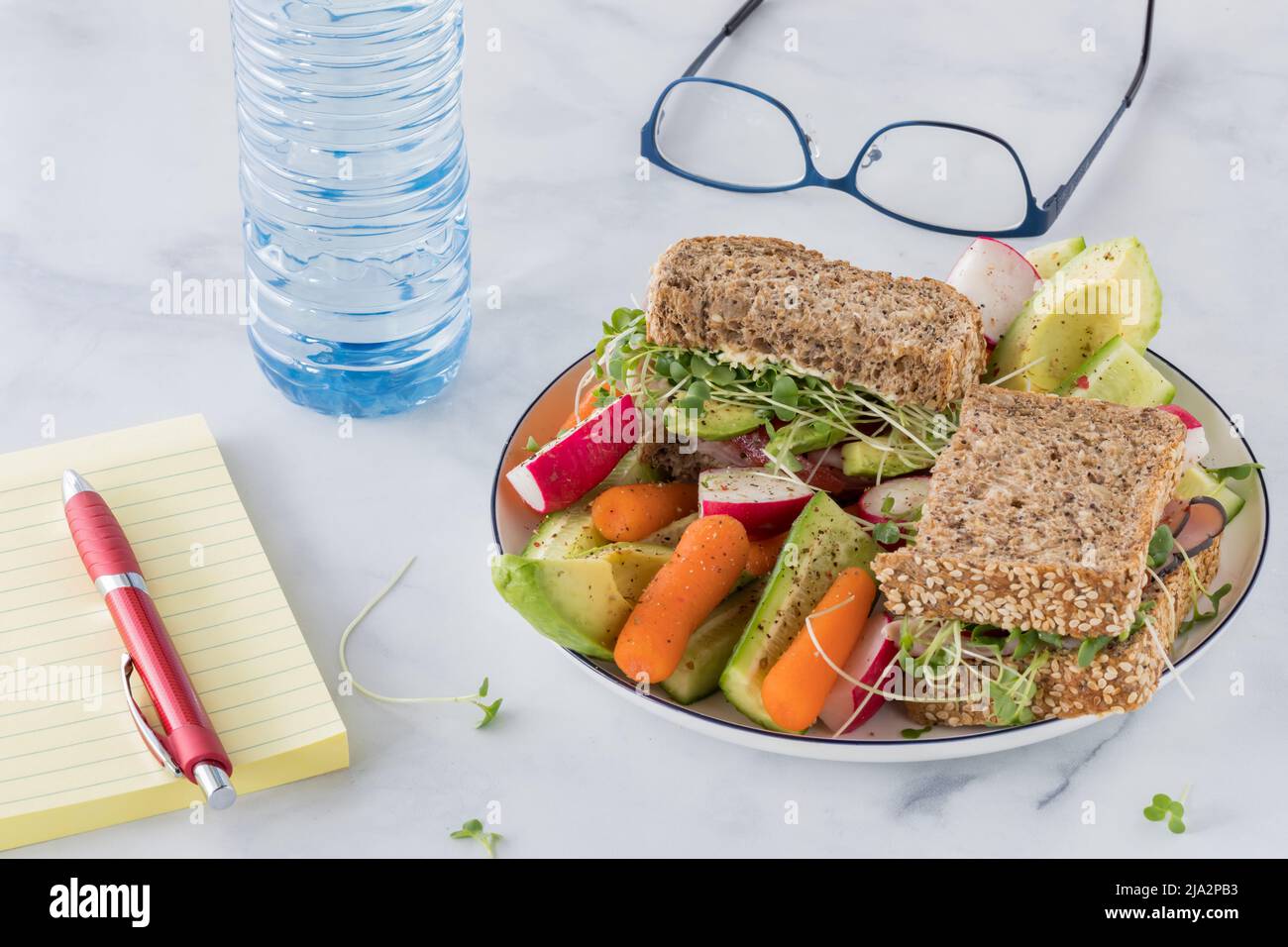 A whole grain cape seed bread sandwich with fresh cut vegetables for lunch. Stock Photo