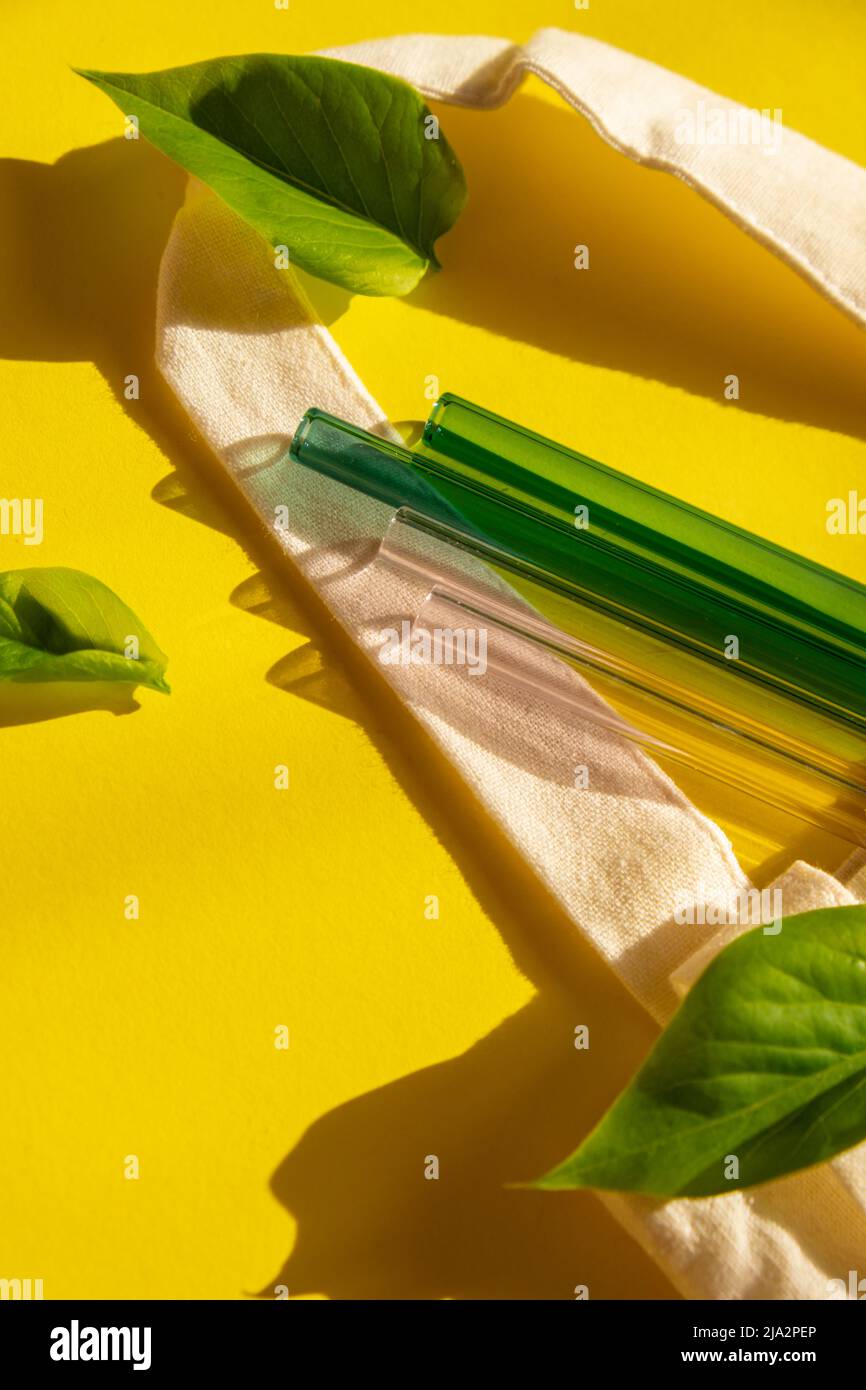 https://c8.alamy.com/comp/2JA2PEP/reusable-glass-straws-on-colorful-background-with-green-leafs-in-eco-bag-eco-friendly-drinking-straw-set-reusable-comfortable-rounded-tip-drinking-straw-zero-waste-plastic-free-concept-sustainable-lifestyle-picnic-concept-2JA2PEP.jpg
