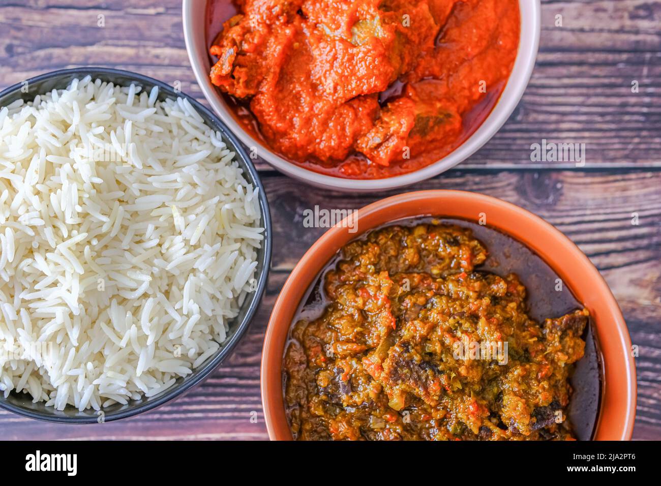 Bowl of rice served with Ofada and Pepper tomato stew Stock Photo Alamy