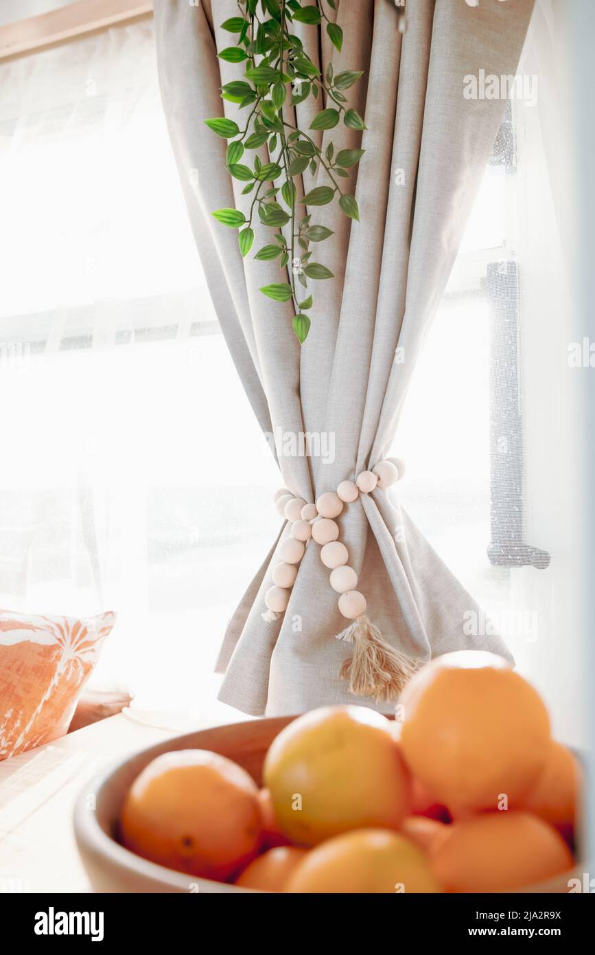 Vintage caravan diy curtains and decor with oranges in a fruit bowl. Stock Photo
