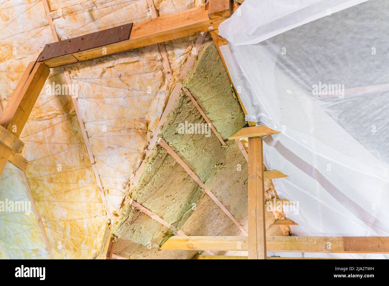 Two layers of insulation on the roof are covered with a vapor barrier