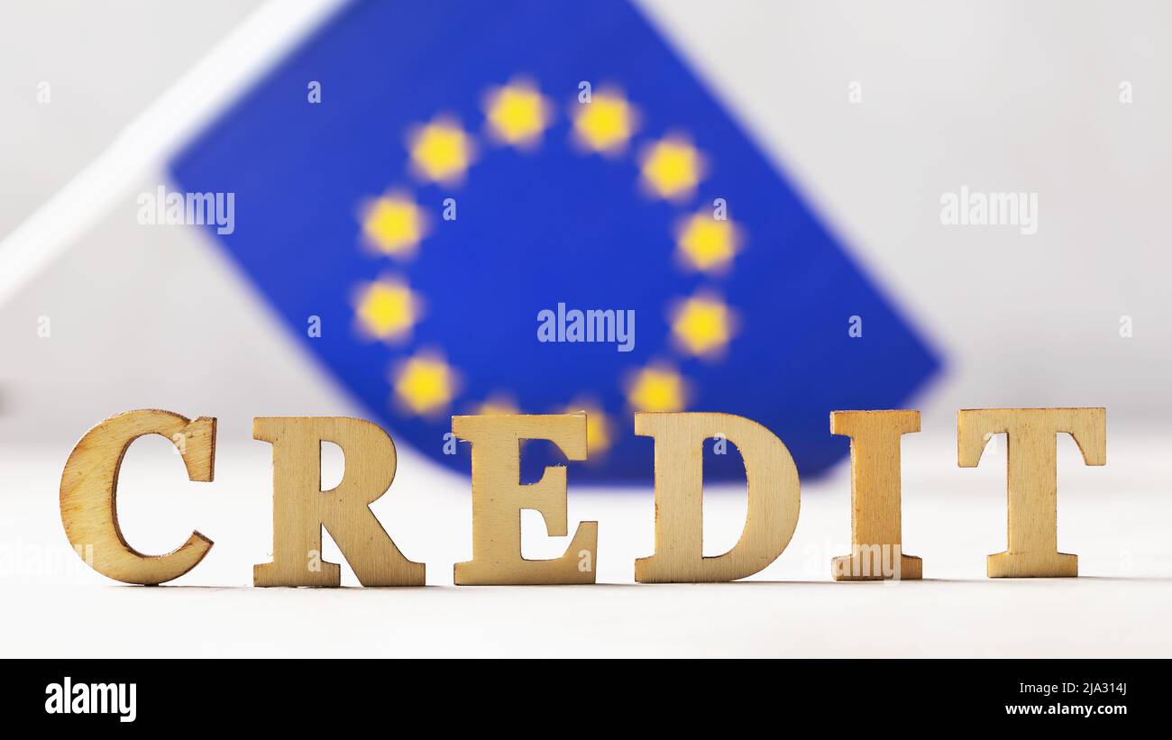 Wood lettering text and EU flag on abstract background, loan concept from European Union Stock Photo