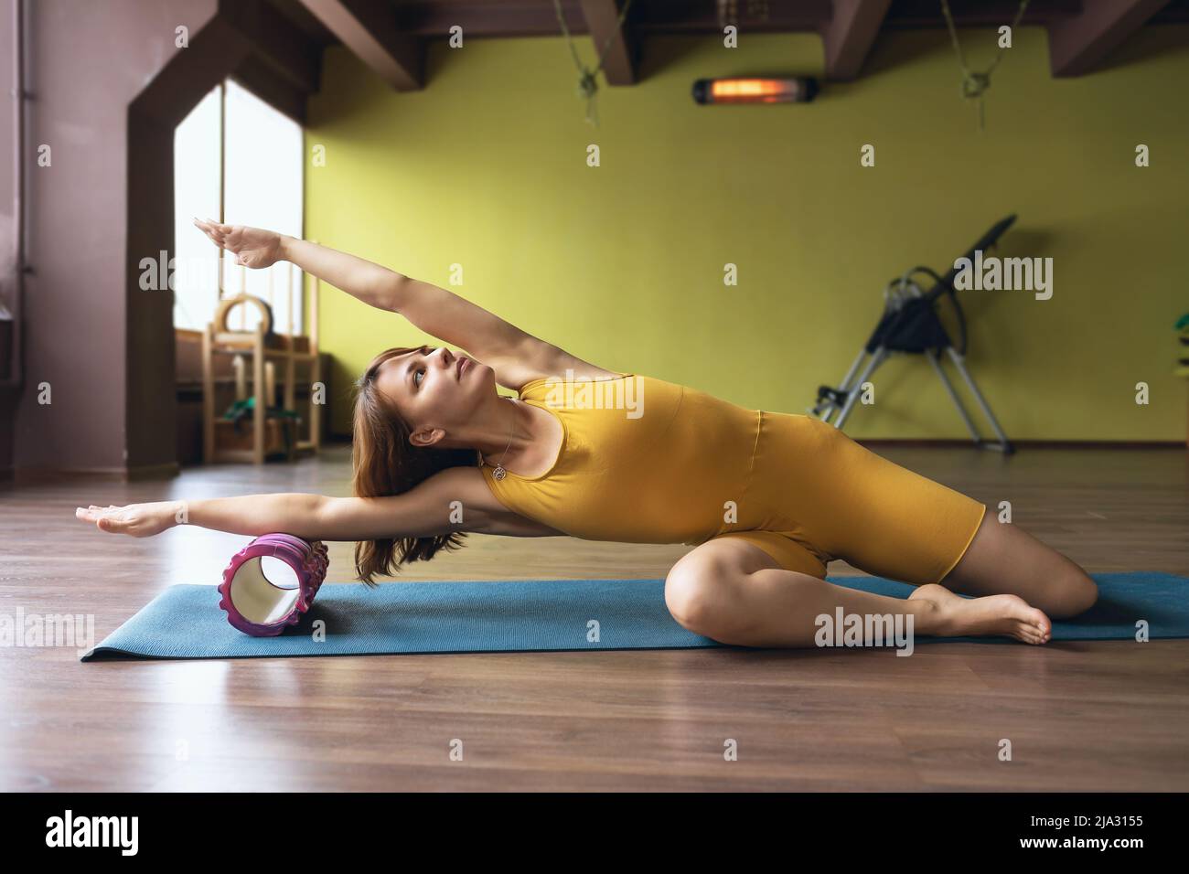 Message Forearms A woman in sportswear performs a massage of the muscles of the forearms ...