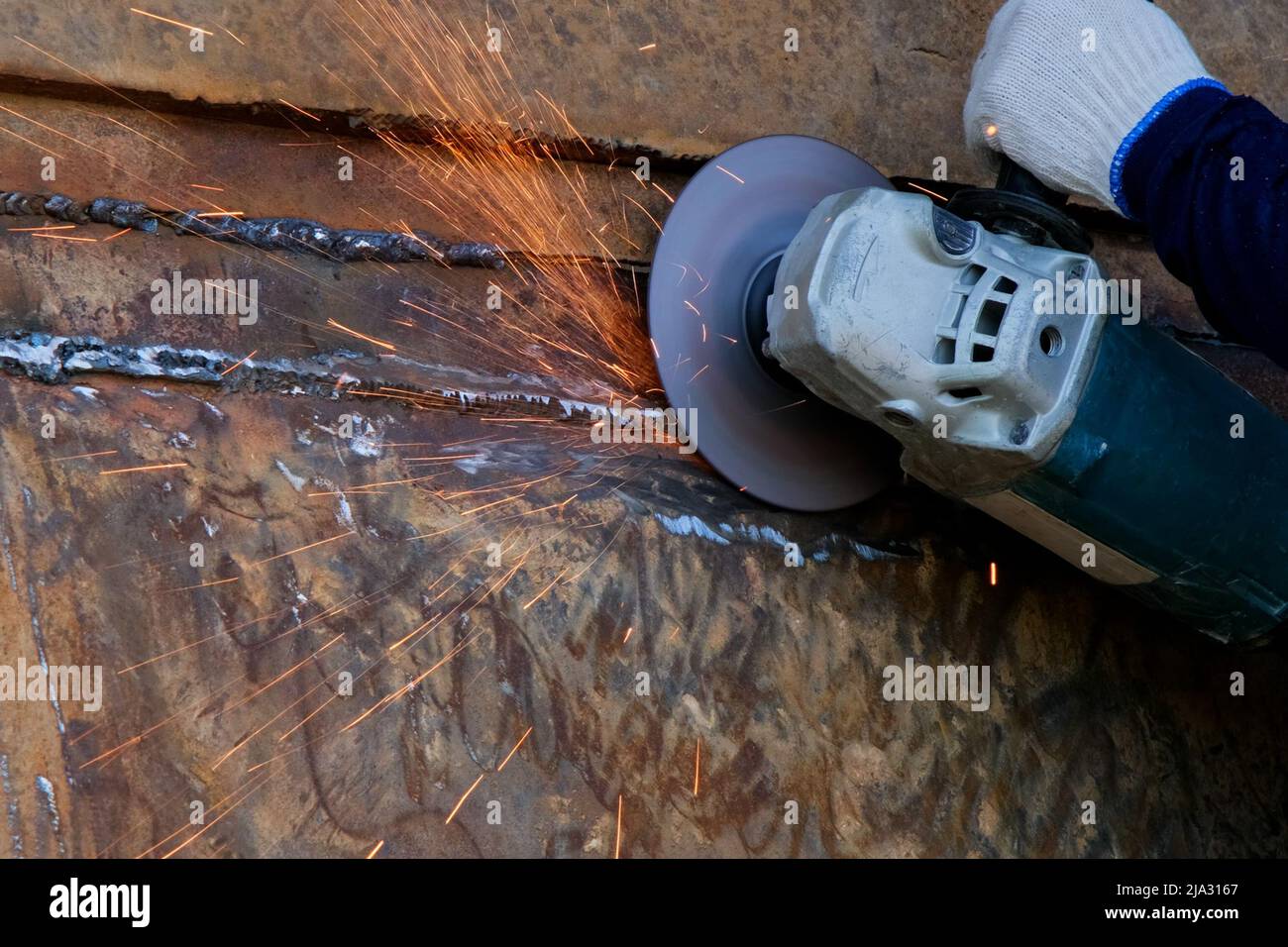 Professional men wearing goggles and construction gloves work in home