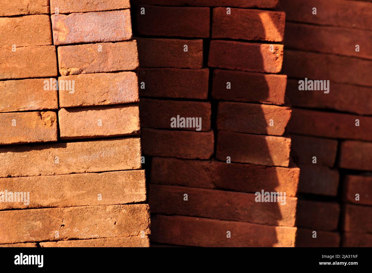 Pile of red bricks texture pattern background Stock Photo