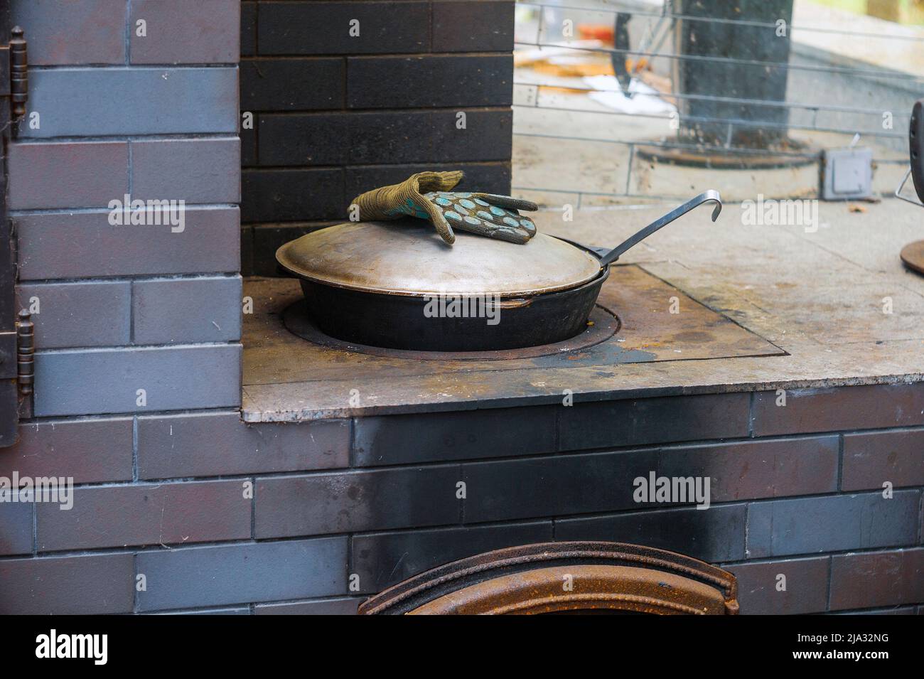 outdoor wood burning stove with abandoned castiron pot, outdoor shot