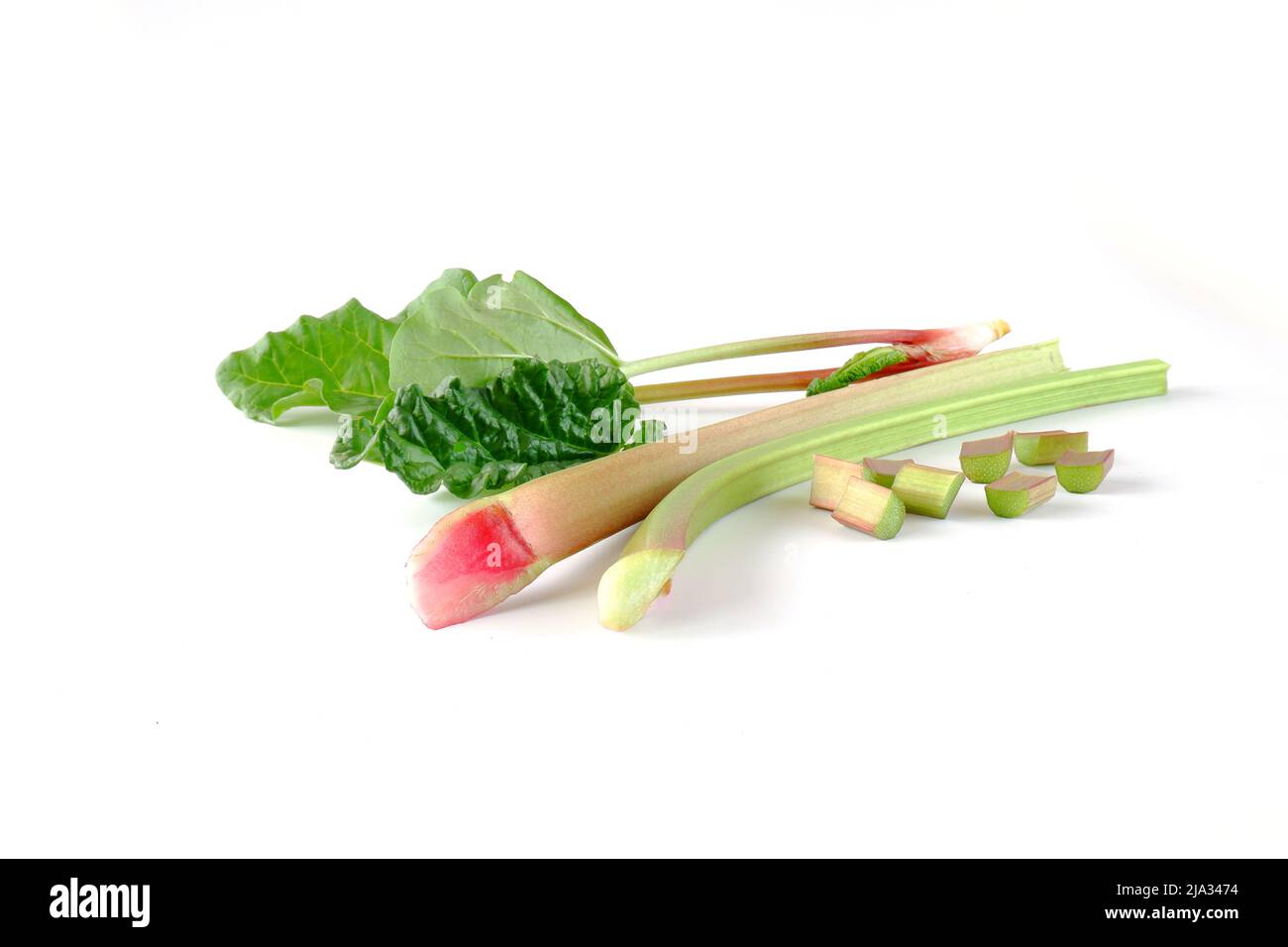 Red and green rhubarb stalks with leaves, rhubarb pieces isolated on a white background. Fresh useful plant from the garden. Stock Photo