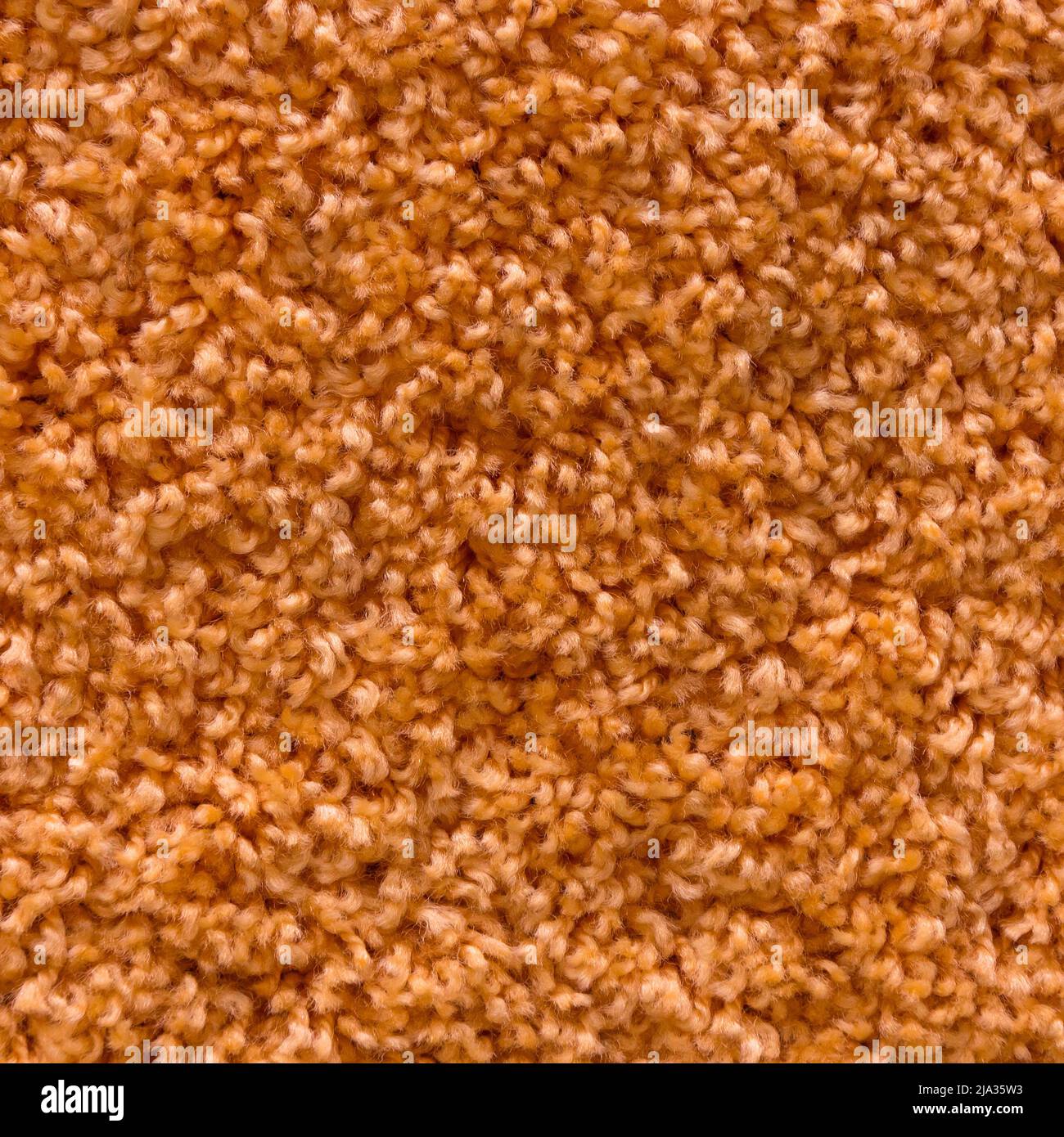 Carpet texture. Orange carpet background close up. Stock Photo