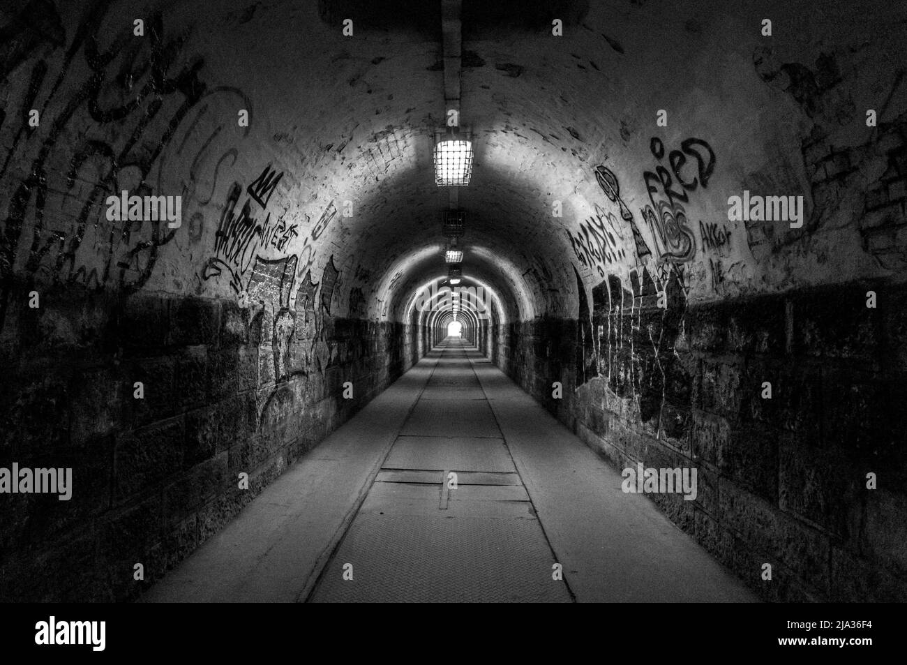 Budapest, Hungary - March 25, 2018: Light at the end of tunnel black and white.Grain added Stock Photo