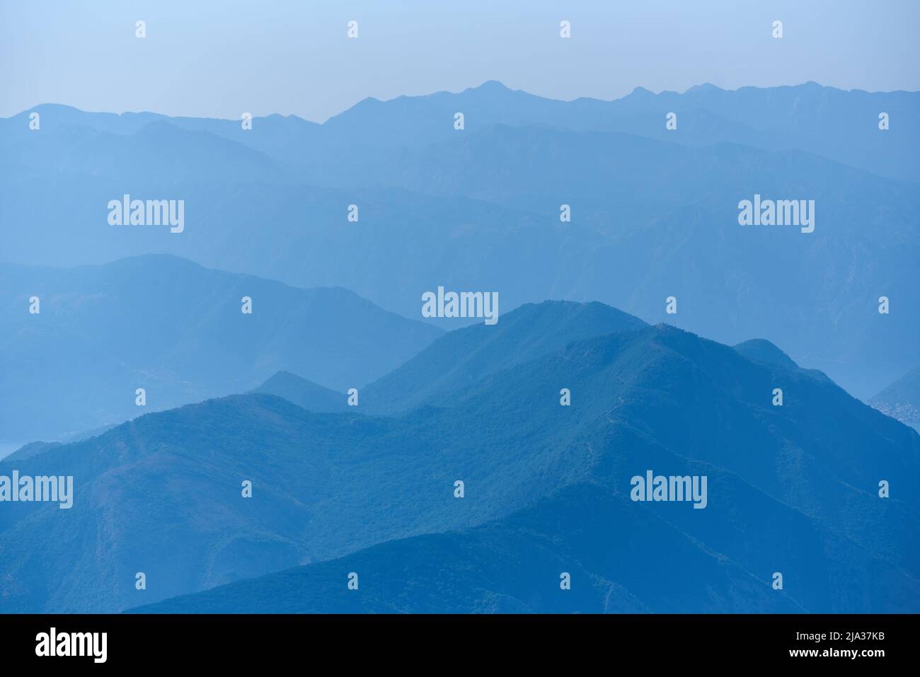Blue mountain range silhouette with morning haze Stock Photo