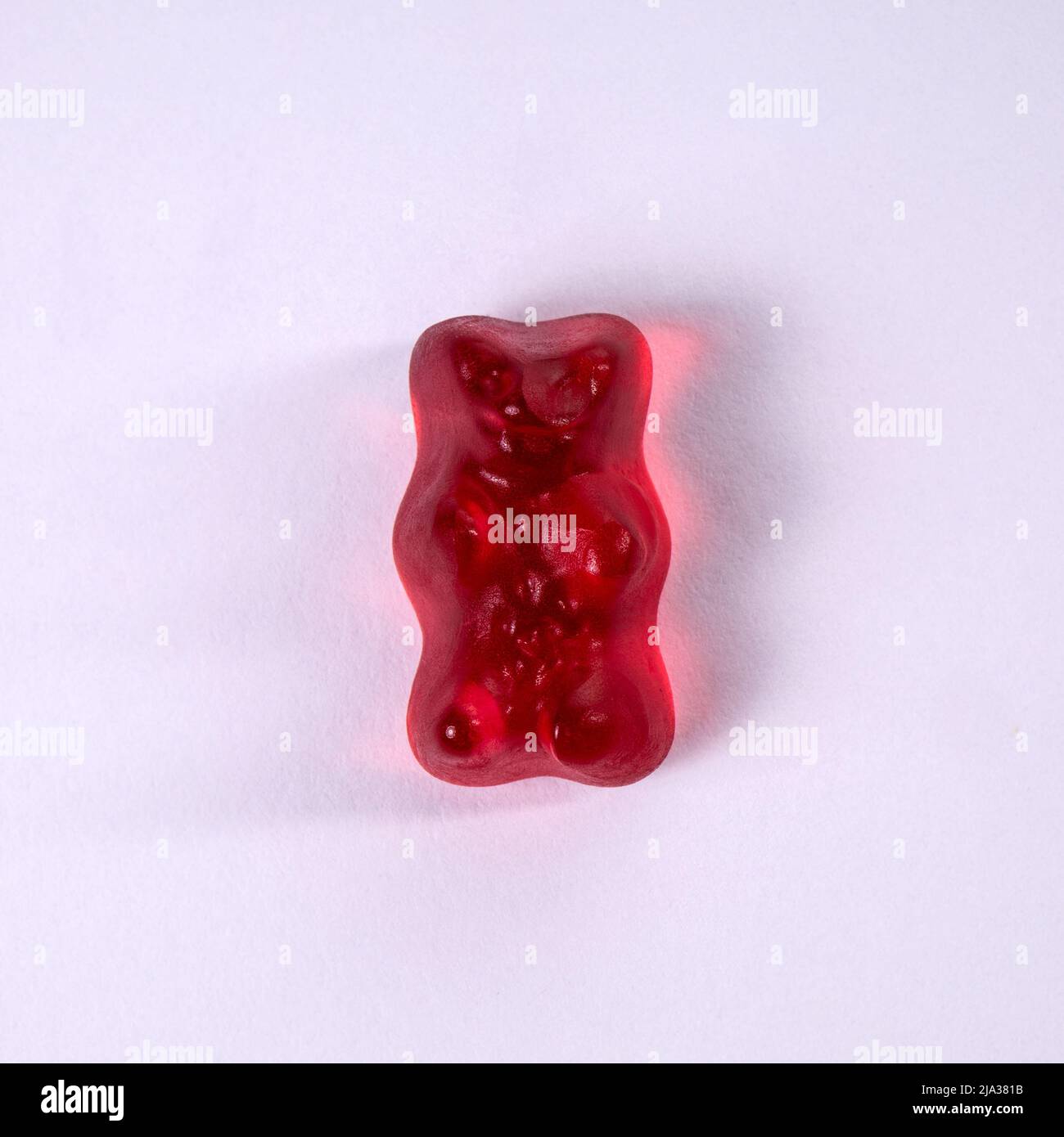 Red rubber bear on a white background. Stock Photo