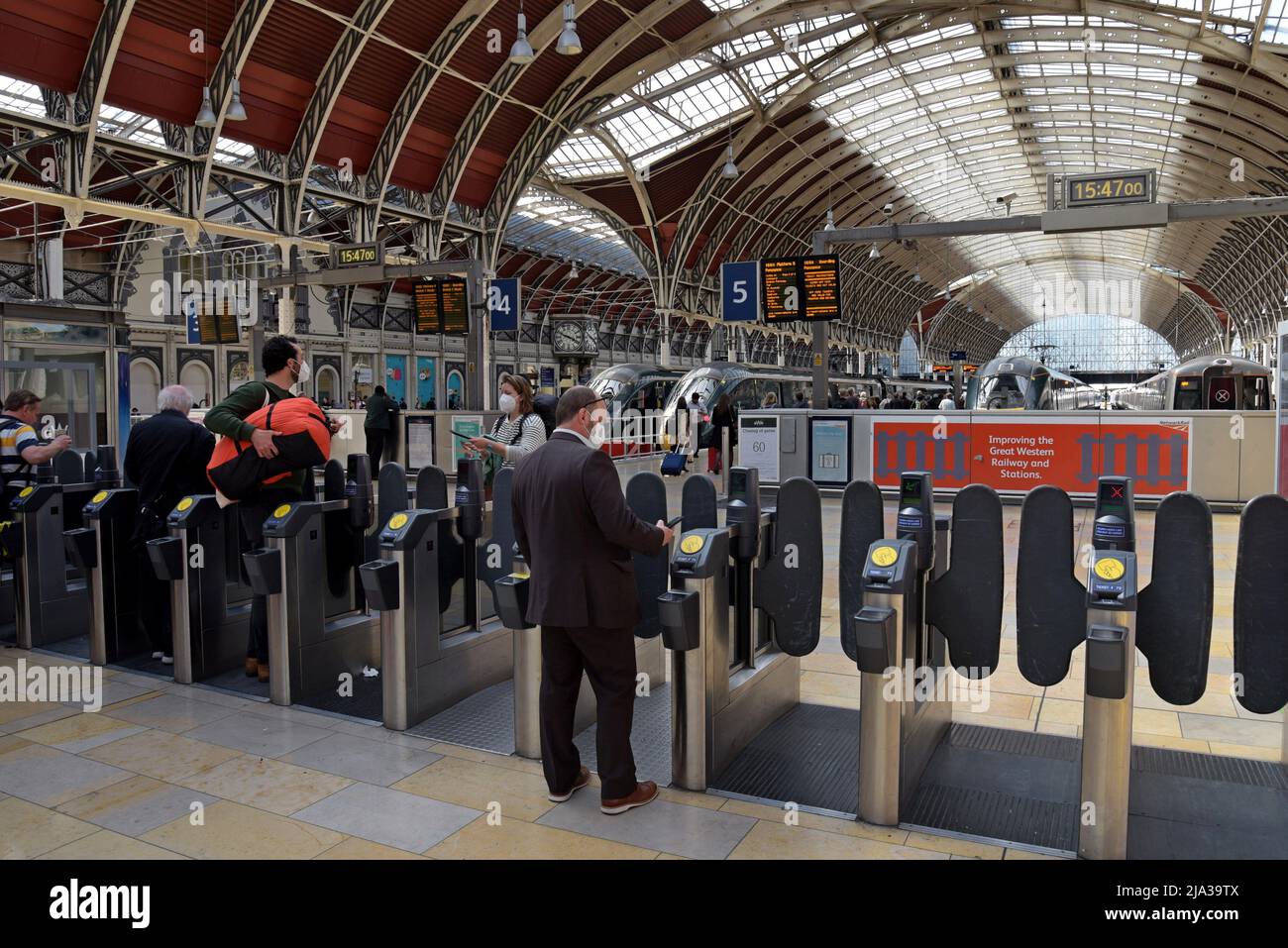 Passengers at Paddington Station in London entering the ticket barrier