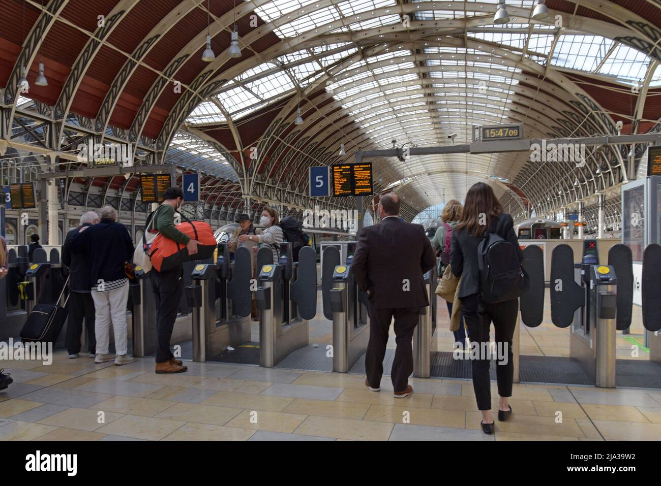 Passengers at Paddington Station in London entering the ticket barrier