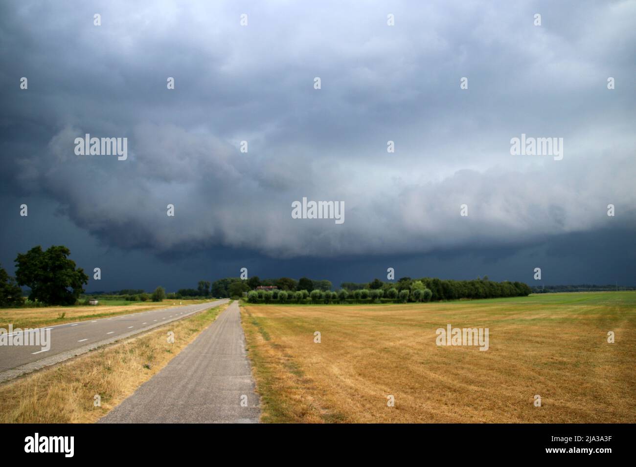 Big wall cloud above the fields in Overijssel in the Netherlands with thunderstorms coming up in the Summer Stock Photo