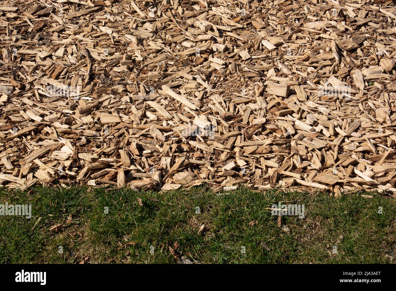 part of path leading through the meadow made of wood chips in a garden Stock Photo