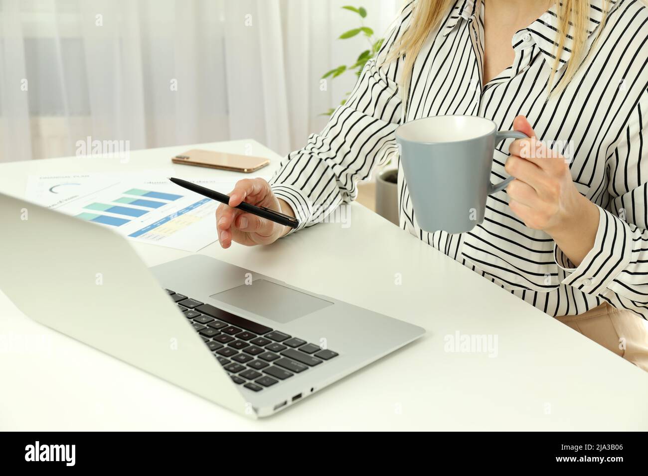 Young business woman sitting on workplace or work table Stock Photo