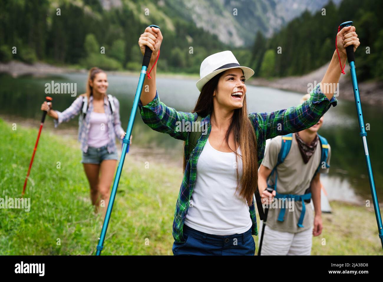 Group of fit healthy friends trekking in the mountains Stock Photo - Alamy