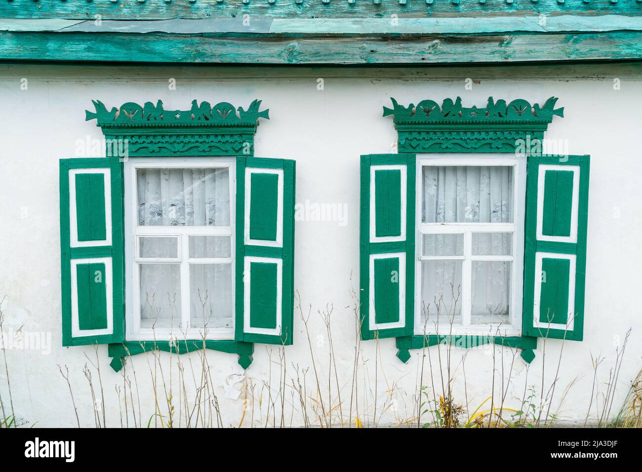 Carved wooden windows in old wooden houses in Oleshnia village, Chernihiv region, Ukraine. Ukrainian culture heritage Stock Photo