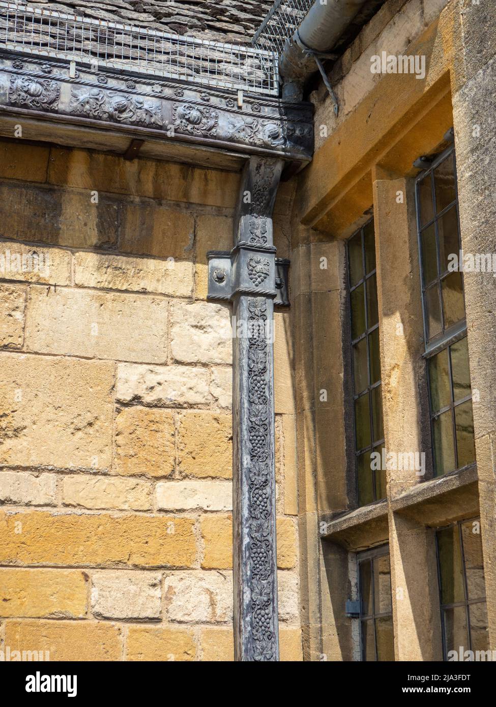 Decorated lead rainwater down pipe on the exterior of the Lygon Arms Hotel, in the Cotswold town of Broadway, Worcestershire, UK Stock Photo