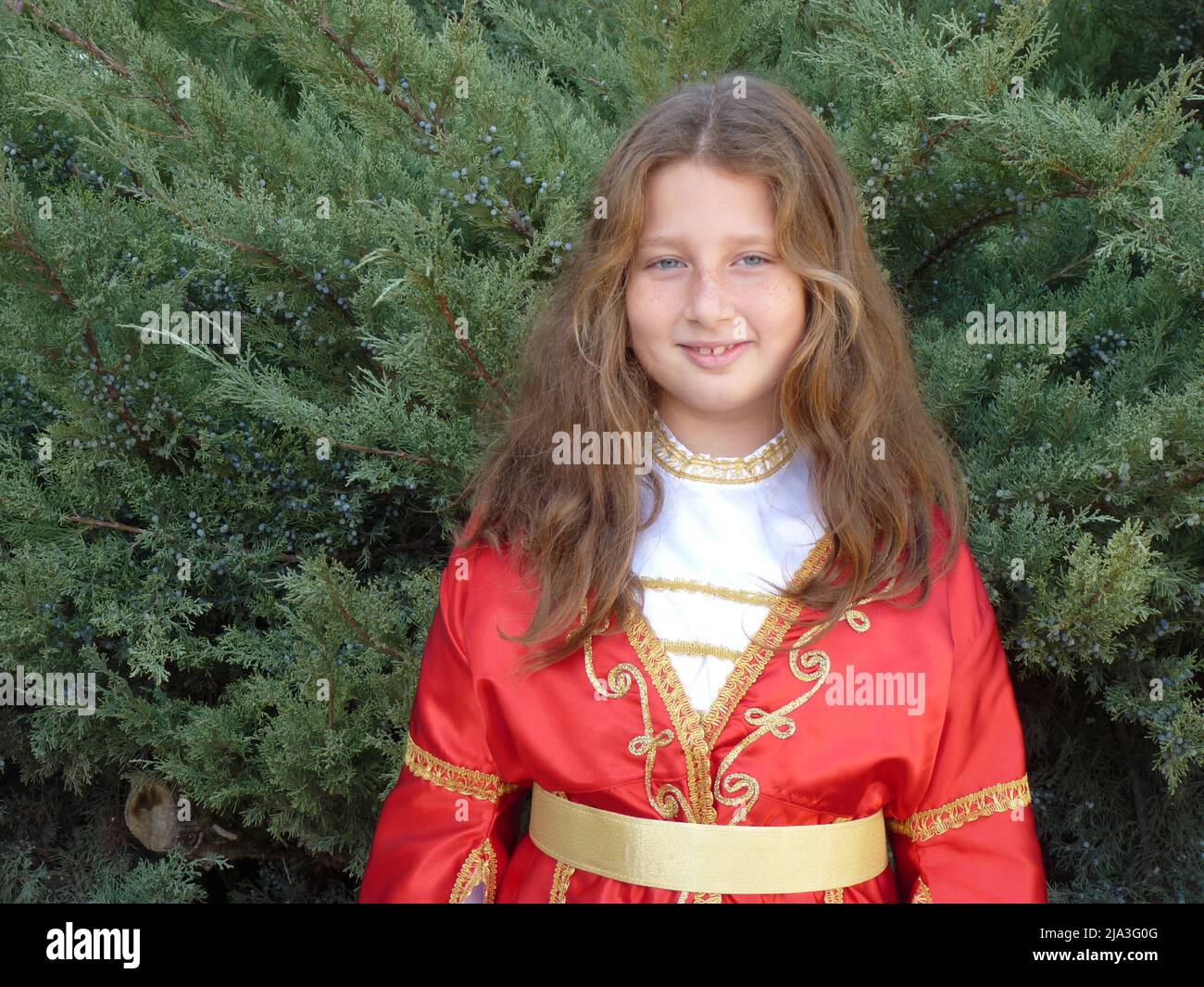 blue-eyed wavy-haired turkish girl in a folklore outfit Stock Photo