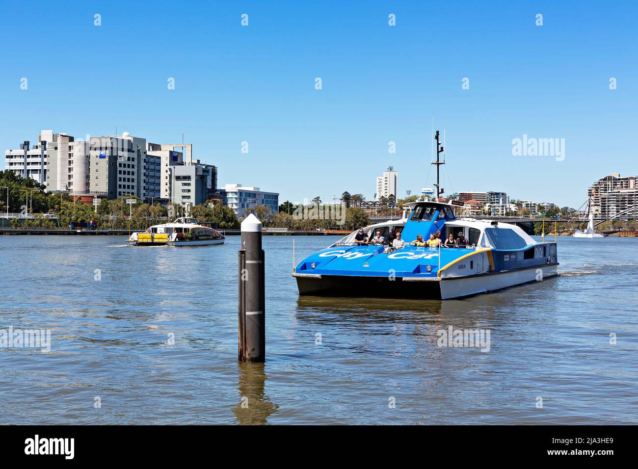 Brisbane Australia /  A fast City Cat Ferry carries passengers along the Brisbane River. Stock Photo