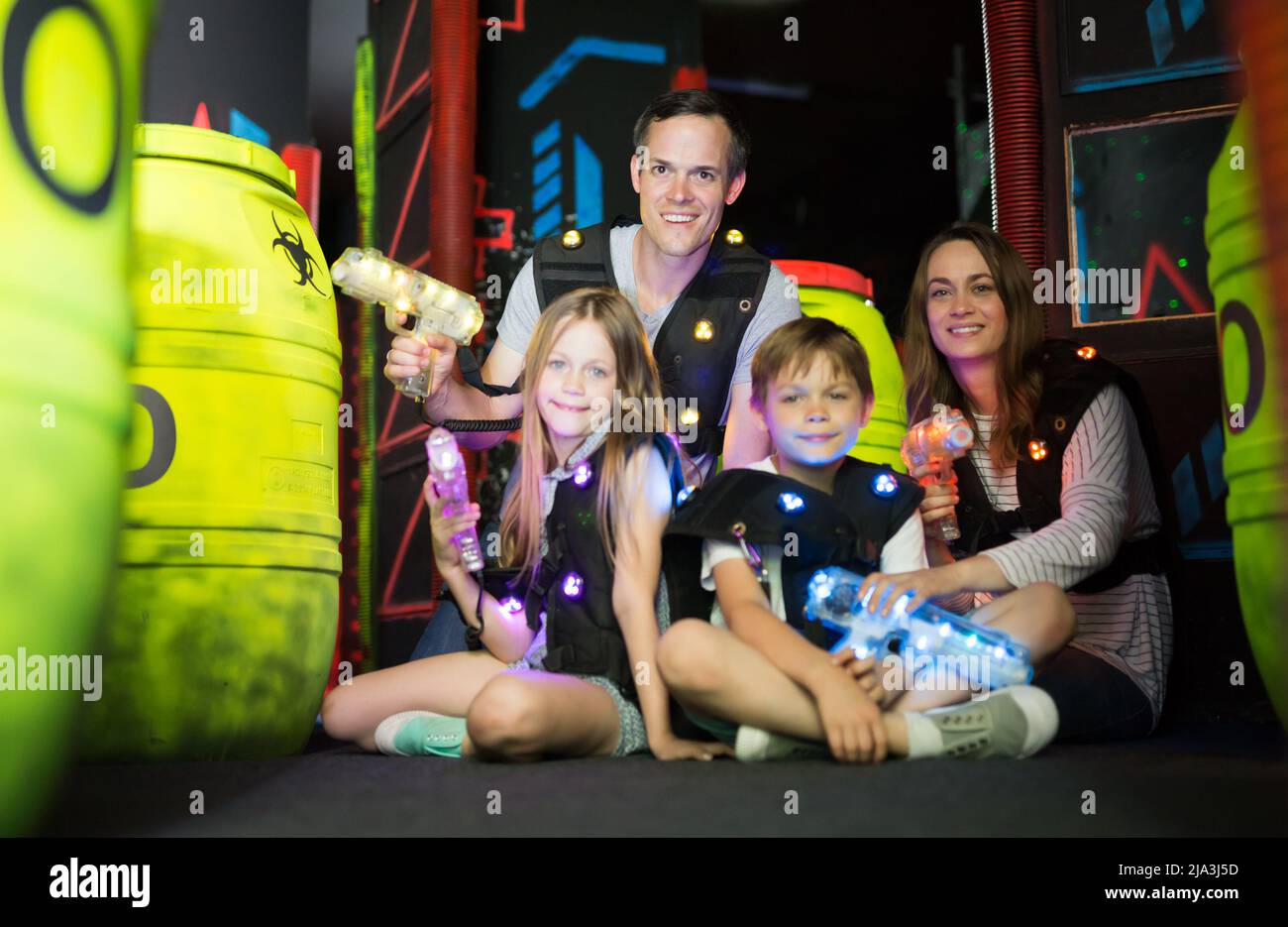 Kds and adults posing with laser guns Stock Photo Alamy