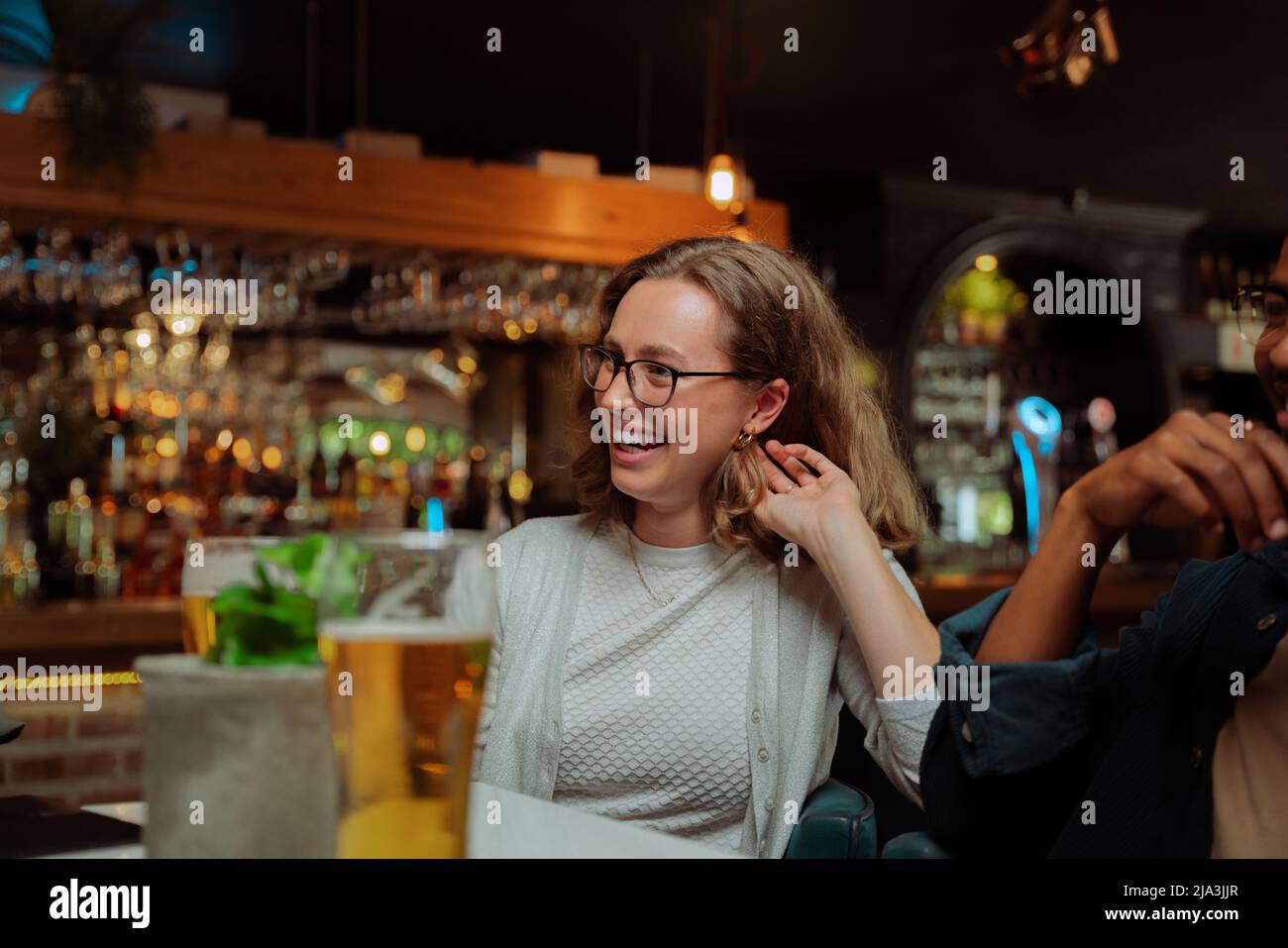 diverse work friends out for dinner laughing  Stock Photo