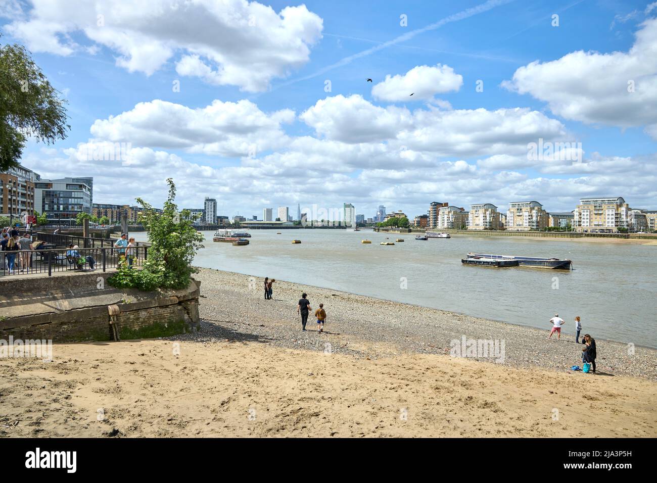 Isle of Dogs, London viewed from across the Thames at Greenwich at low tide, showing the beach. Stock Photo