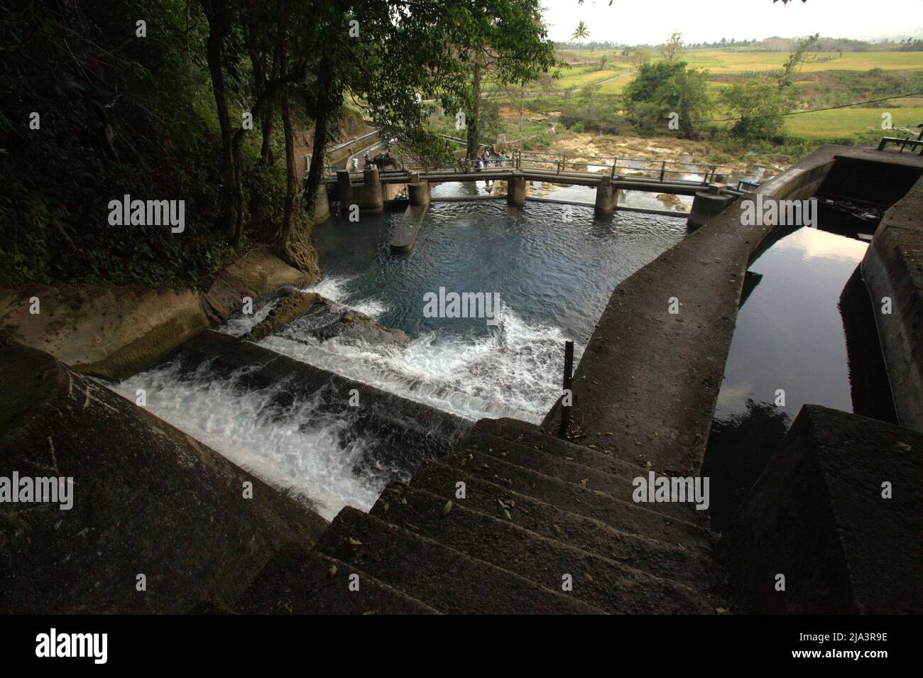 A waterfall and dam at limestone caves of Waikelo Sawah, a rare water source in Sumba—an island regularly hit by drought, which is located in Tema Tana village, East Wewewa, Southwest Sumba, East Nusa Tenggara, Indonesia. Stock Photo