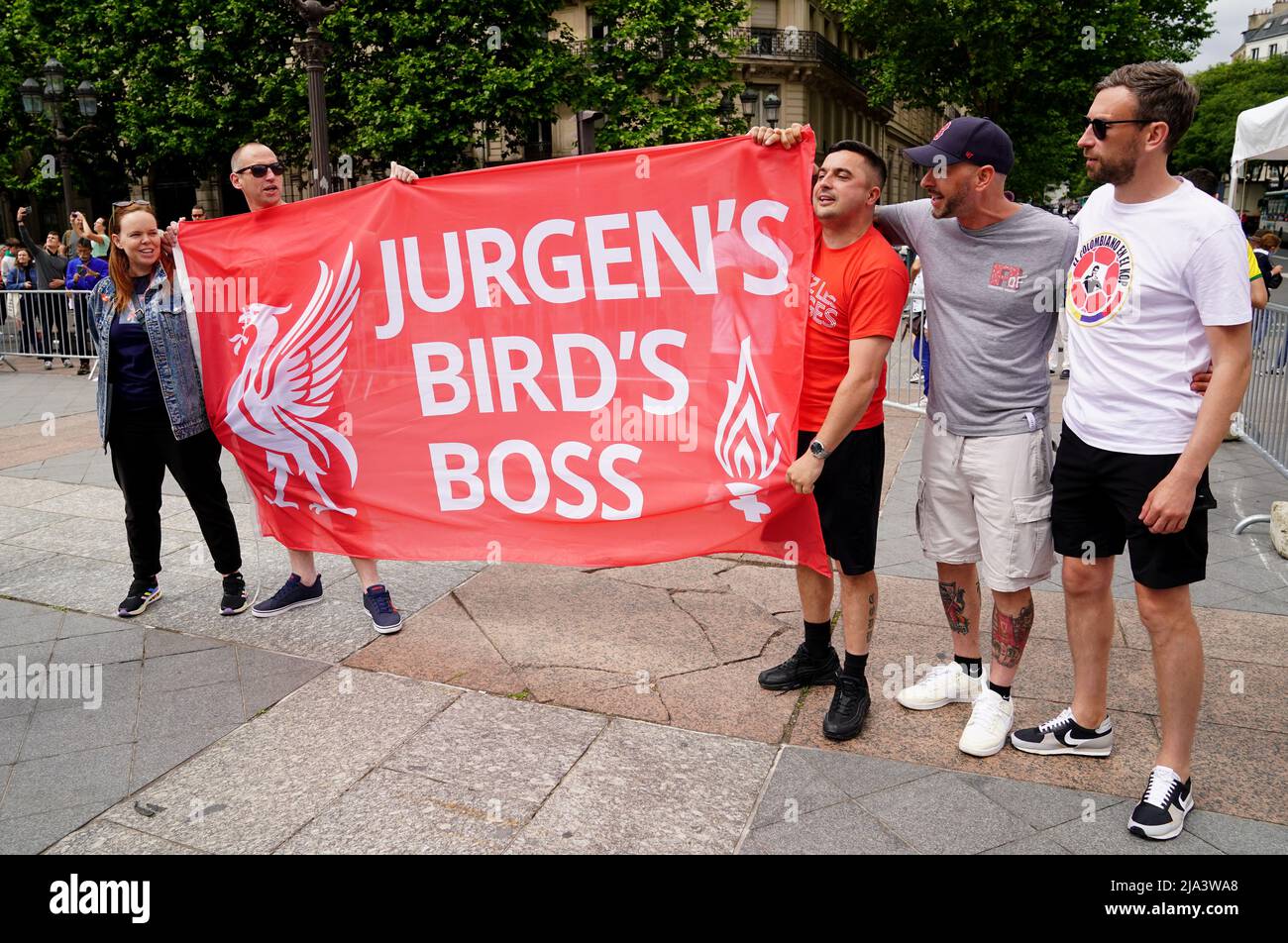 Liverpool fans hold a flag of support at the Trophy Experience at The Place de l'Hotel de Ville in Paris ahead of Saturday's UEFA Champions League Final at the Stade de France, Paris. Picture date: Friday May 27, 2022. Stock Photo