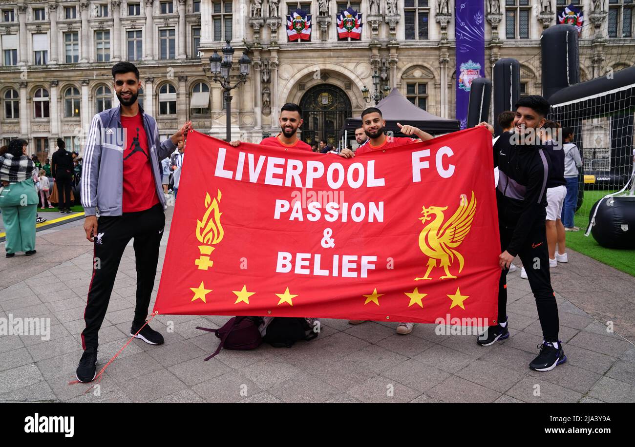 Liverpool fans hold a flag of support at the Trophy Experience at The Place de l'Hotel de Ville in Paris ahead of Saturday's UEFA Champions League Final at the Stade de France, Paris. Picture date: Friday May 27, 2022. Stock Photo