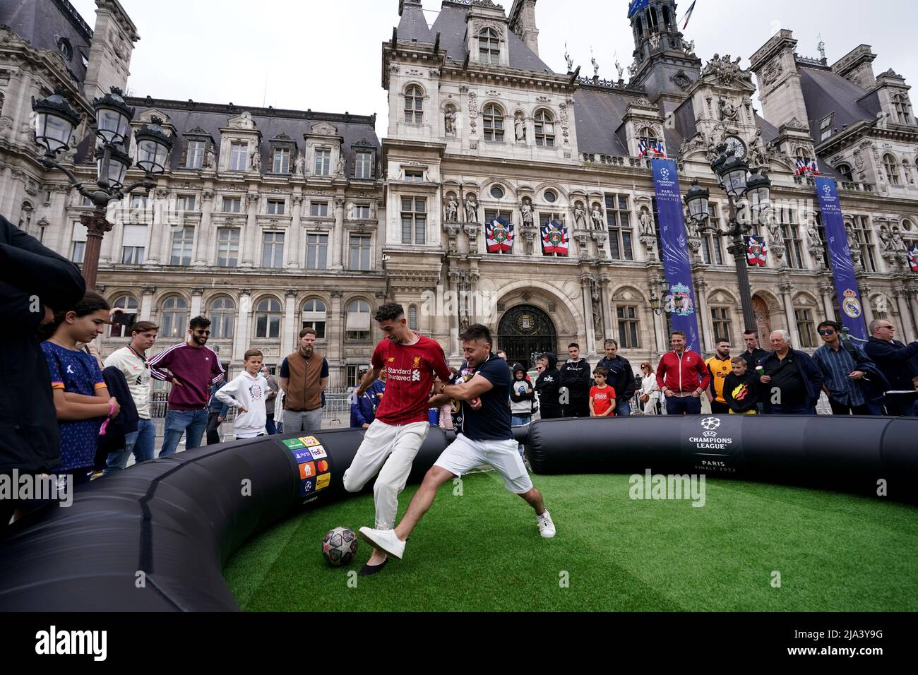 Fans play on a mini pitch at the Trophy Expierence at The Place de l'Hotel de Ville in Paris ahead of Saturday's UEFA Champions League Final at the Stade de France, Paris. Picture date: Friday May 27, 2022. Stock Photo