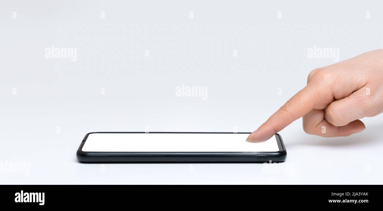 Mockup cellphone. Woman finger presses on screen. Smart phone on white