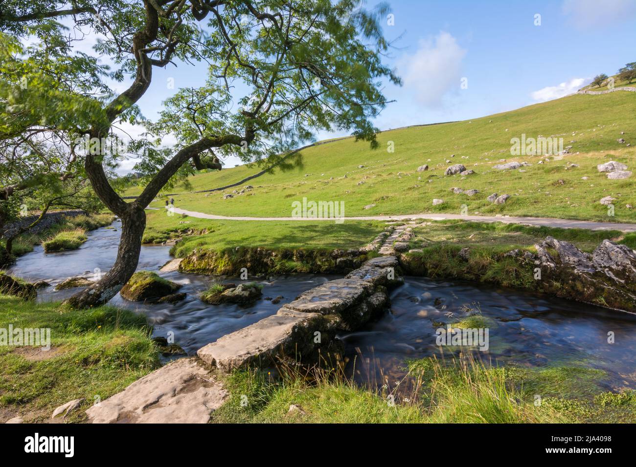 Improvised stone bridge over Malham Cove stream in the Yorkshire Dales National Park. Visited during the Dales High Way long distance walk. Stock Photo