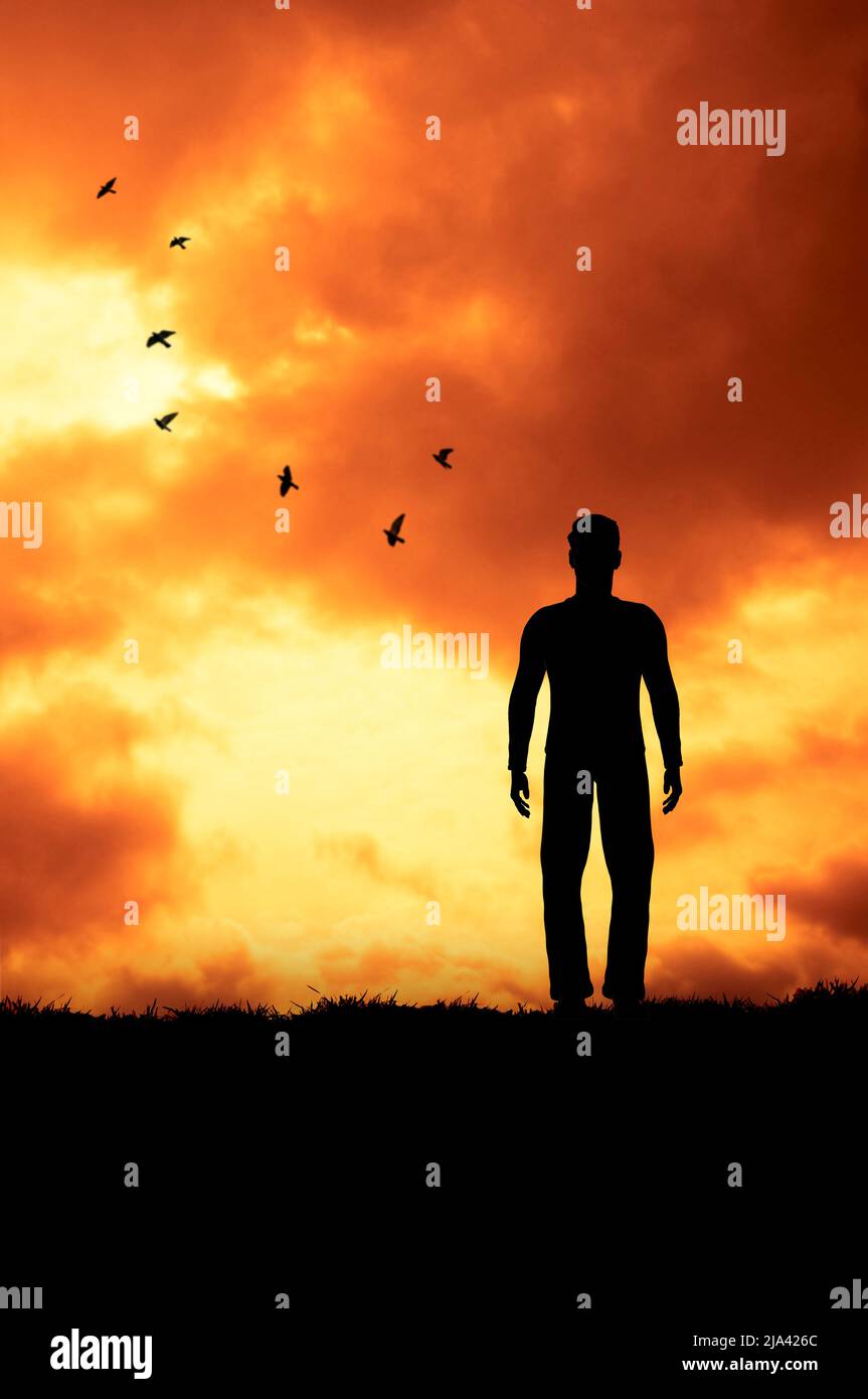 silhouette of a man standing on the edge of a cliff at sunset Stock ...